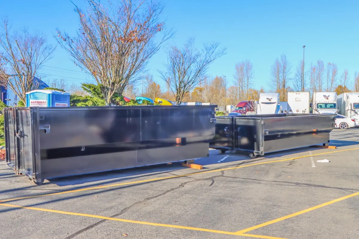 Professional dumpster rental service with roll-off container on residential driveway in Prairie Village